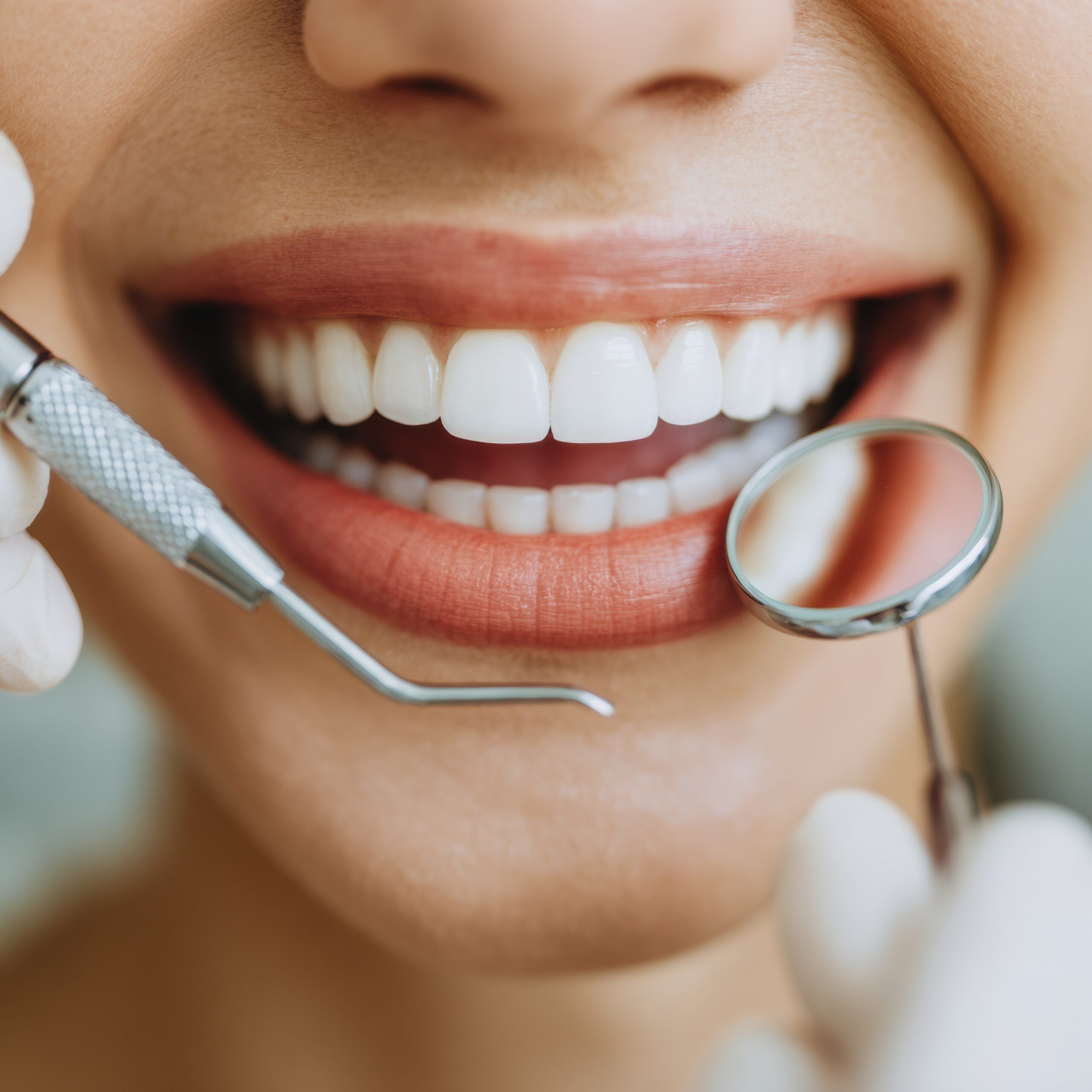Young miserable woman experiencing severe toothache, pressing palm to cheek, closing eyes because of strong pain, isolated on gray background