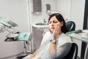 Woman with toothache at dentist office.
