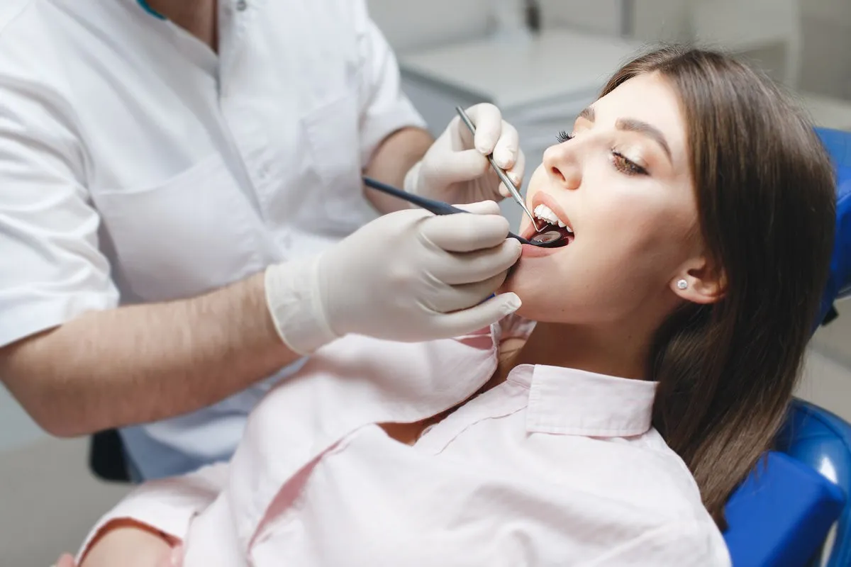 Beautiful young woman visiting dentist