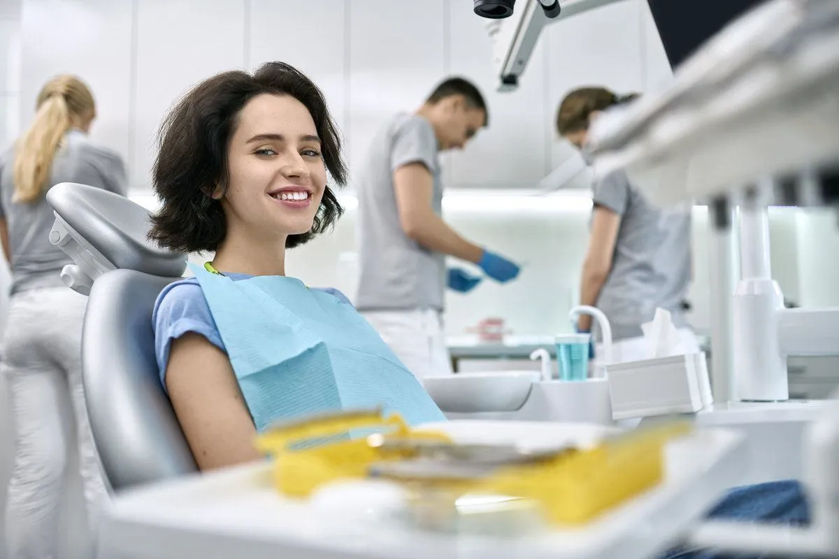 Pretty woman's teeth treatment in dental clinic
